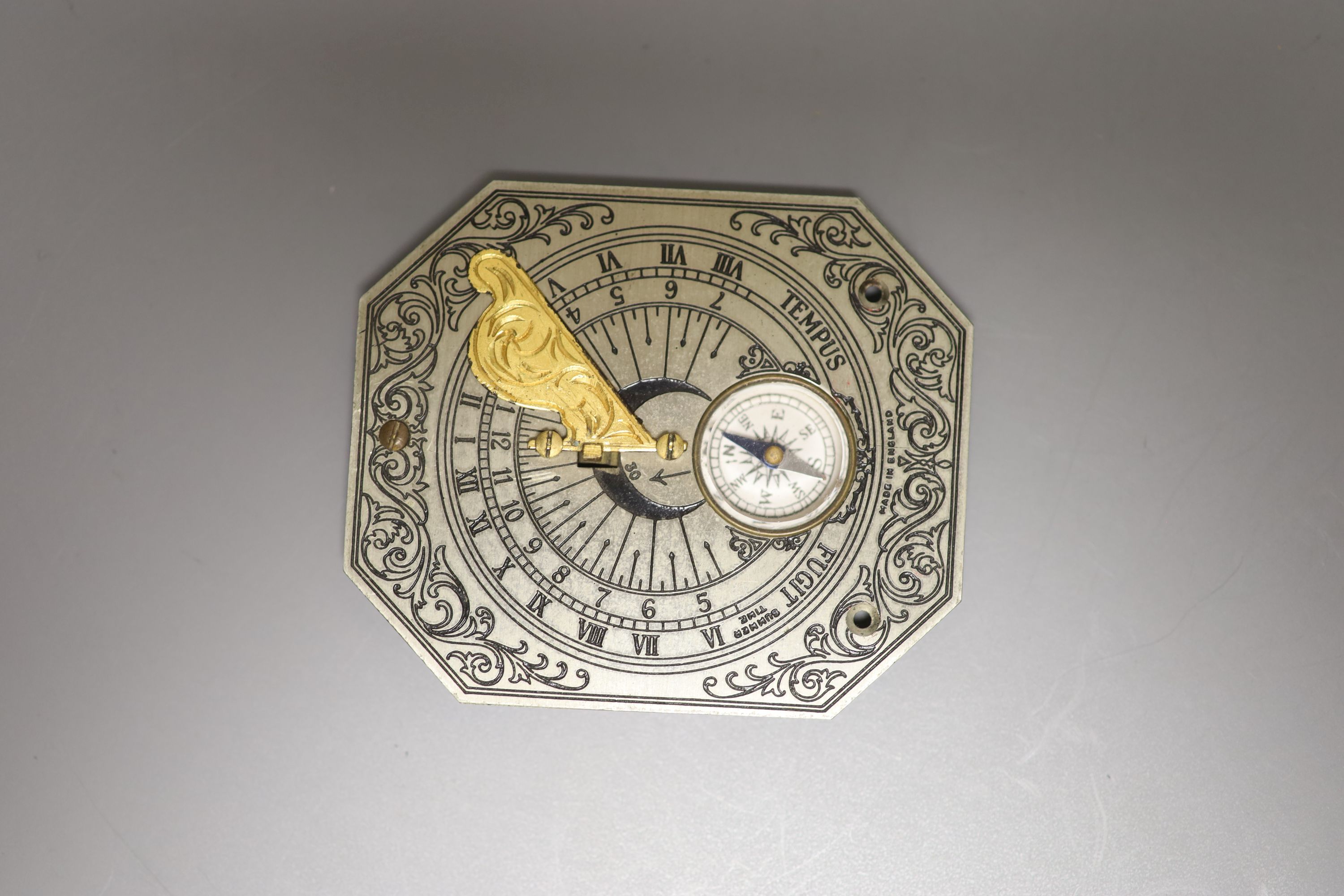 A reproduction Butterfield style scale and a Chinese compass/sundial, longest 12cm